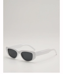 Detail view of thick white cat eye frame sunglasses with geometric temples and dark lenses