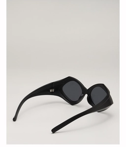 Close-up of black geometric irregular sunglasses with thick temples and wide hip-hop style
