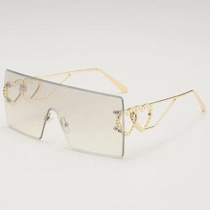 Oversized rimless square sunglasses with gold metal temples and hollow heart detail
