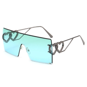 Oversized rimless square sunglasses with gradient blue lenses and heart chain temples