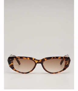 Detail view of tortoiseshell cat-eye sunglasses with brown gradient lenses and frame