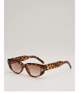 Detailed close-up of tortoise shell cat-eye sunglasses with gradient brown lenses