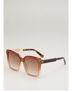 Detail view of square gradient sunglasses with tortoiseshell temples and gold accents