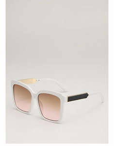 Detail view of large white square sunglasses with brown gradient lenses and gold temple decor