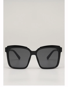 Front detail of large square oversized sunglasses with polished black frames and dark lenses