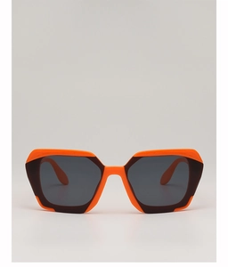 Detail of trendy geometric sunglasses with orange and burgundy frame and dark lenses