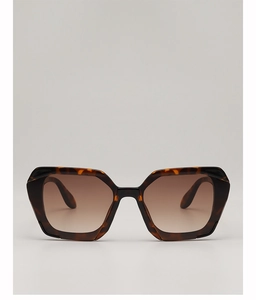 Close-up of stylish tortoiseshell geometric sunglasses with brown gradient lenses