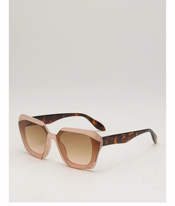 Detail view of geometric sunglasses featuring a pink frame and tortoiseshell patterned temples
