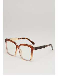 Close-up of oversized square sunglasses with tortoiseshell gradient frames and gold metal hinge