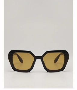 Close-up of retro polygonal sunglasses with oversized black frames and amber lenses