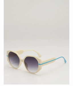 Detail view of oversized polygonal sunglasses with beige frame and blue temple accent
