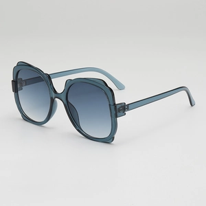 Stylish oversized translucent blue sunglasses with wavy textured frames and gradient lenses