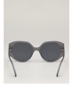 Close-up of translucent grey round sunglasses with high-quality metal hinge details