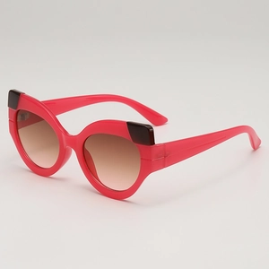 Fashionable bright pink cat eye sunglasses with dark accents and gradient lenses