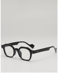 Detail of polygonal black eyeglass frame with silver rivet hinges and thick temples