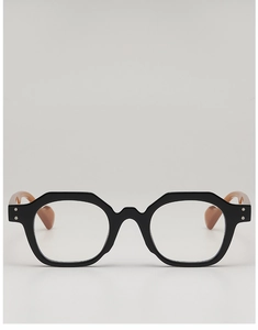 Close-up of vintage polygonal sunglasses with double silver studs and amber temples