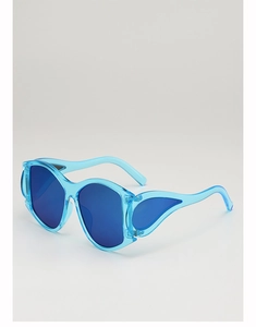 Detail shot of blue oversized wing-shaped punk sunglasses at a 45-degree angle
