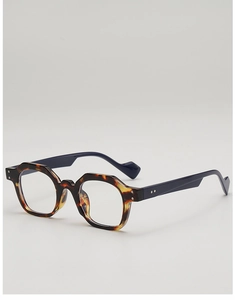 Detail of tortoise shell polygonal frame with blue temples and metal rivet accents