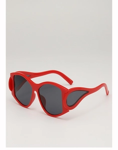 Detail view of bold red punk style oversized sunglasses with flame wing frame design