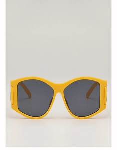 Close-up of bright yellow oversized punk sunglasses with dark grey UV protective lenses