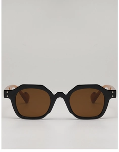 Close-up of vintage geometric sunglasses with black chunky frame and silver rivet details