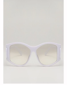Close-up of wide white frame sunglasses with light gradient lenses in a minimal setting