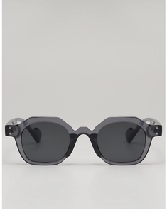Detail of grey translucent polygon sunglasses with metal rivets and dark lenses