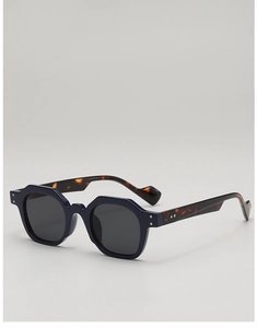 Detailed close-up of retro irregular sunglasses featuring dark tortoise temple and metal rivets