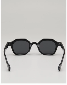 Rear view of black geometric hexagonal sunglasses with thick acetate frames and metal hinges