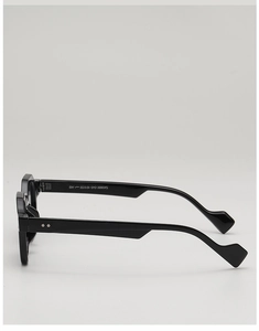 Detail of wide black eyewear temples with geometric diamond-cut ends and metal hinges
