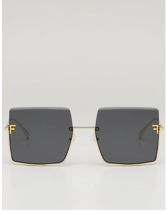 Close-up of gold metal half-frame sunglasses with square lenses and crystal F detail