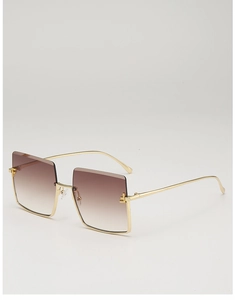 Detailed view of oversized square sunglasses with metal half-frame and gradient brown lenses