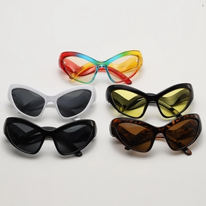 Flat lay of futuristic butterfly sunglasses in multiple colors and textures