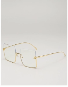 Close-up of golden oversized square semi-rimless frame with slim metal temples