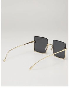 Detail of metal frame and temple connection on large square rimless sunglasses