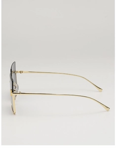 Detail of metal sunglasses with golden frame, dark lenses and embossed logo on temple