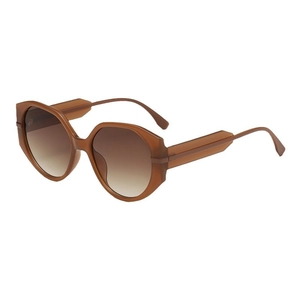 Oversized round amber tortoiseshell sunglasses with brown gradient lenses for travel
