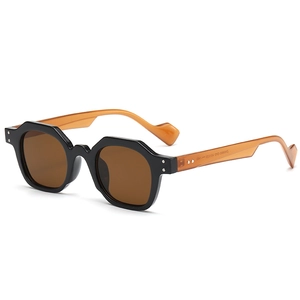 Octagonal geometric sunglasses with black frame and amber wavy arms on white background