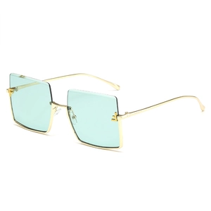 Oversized square half-rim sunglasses with mint green lenses and gold metal frame