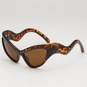 Retro cat-eye tortoiseshell sunglasses with wavy temples and dark brown lenses