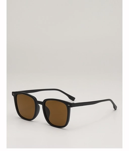 Detailansicht der quadratischen Sonnenbrille mit schwarzem Rahmen und Goldnieten