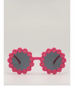 Detail of rose pink baby sunglasses featuring 3D floral frames and round grey lenses