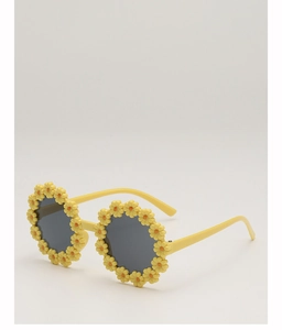 Close-up of yellow daisy-shaped frame and dark lenses on children's sunglasses