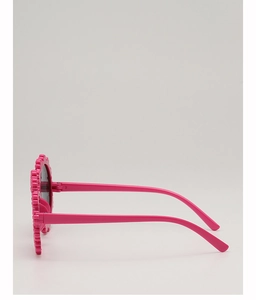 Side view of pink flower-shaped children's sunglasses with UV protection lenses