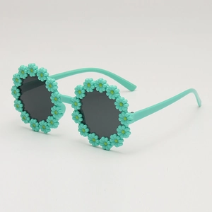 Kids flower-shaped sunglasses with mint green frames and daisy floral accents