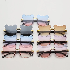 Detailed flat lay of cute bear-shaped children's sunglasses in seven vibrant colors