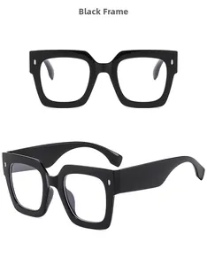 Detail view of black square frame glasses with wide temples and silver rivet accents