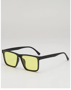 Close-up of retro square sunglasses with matte black frames and yellow tinted lenses
