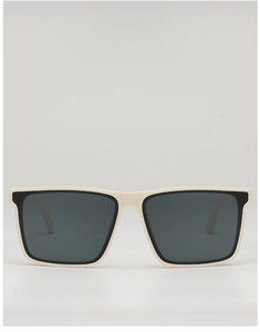 Close-up of cream square frame sunglasses with dark grey lenses on a grey background