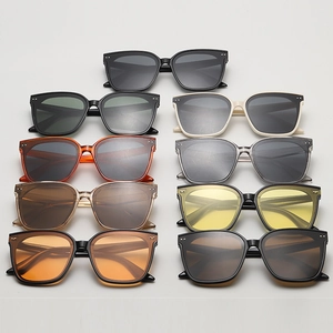 Flat lay of stylish square sunglasses in various colors featuring metal rivet accents